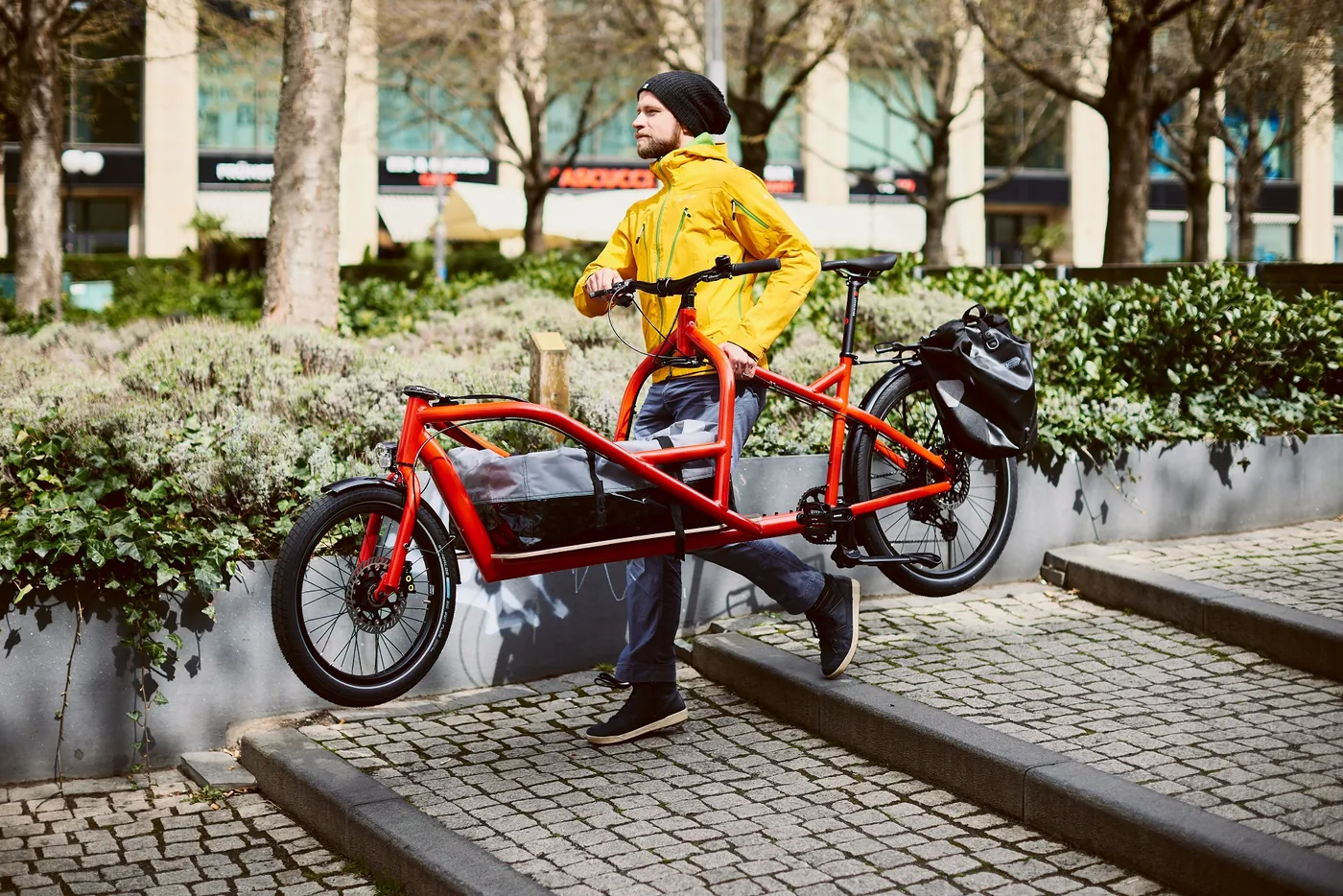 Fahrer trägt ein Velo Lab Lastenrad eine Treppe hinunter